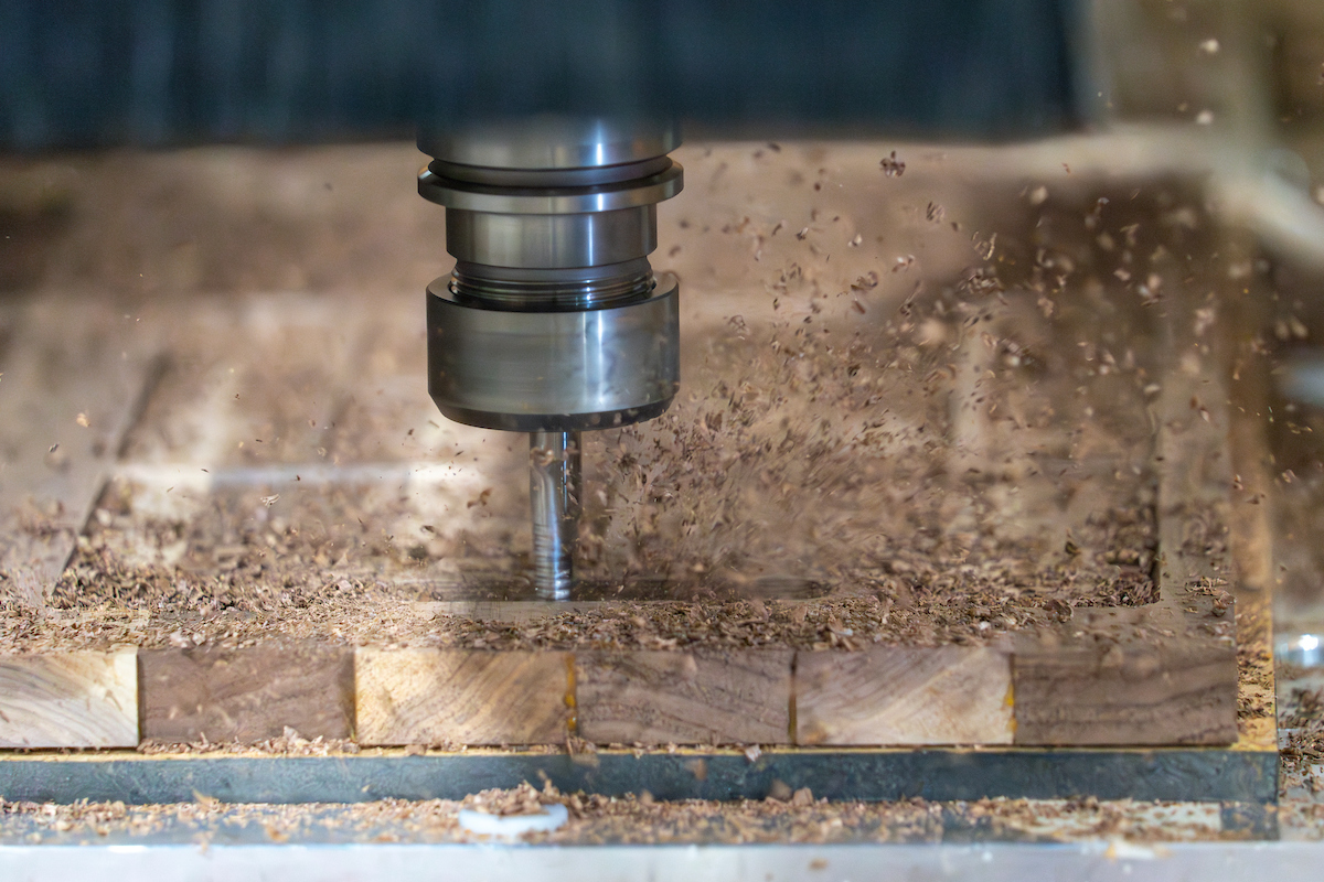Close up of an automted machine cutting lumber.